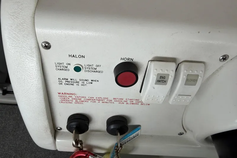 Slide: The Image of Control panel of a 2000 Formula 353 FASTech boat with switches and warning labels. - 22