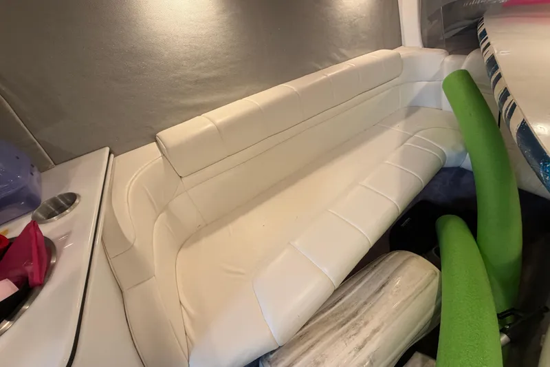Slide: The Image of Interior of 2000 Formula 353 FASTech boat with white seating and green accents. - 31