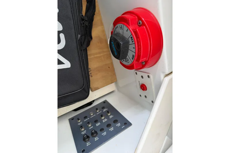 Slide: The Image of Control panel of a 2000 Formula 353 FASTech boat with red dial and switches. - 32