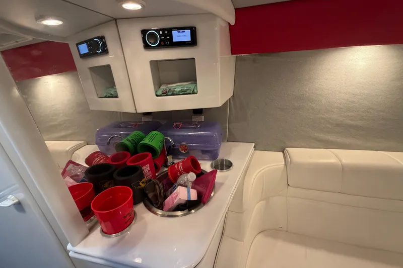 Slide: The Image of Interior of a 2000 Formula 353 FASTech boat with white seating and storage area. - 34