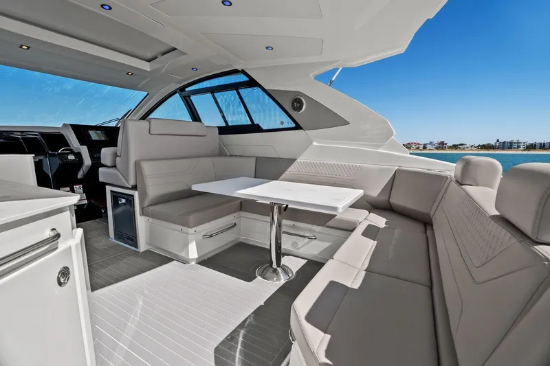 Slide: The Image of Luxurious interior of 2026 Cruisers Yachts 42 GLS OB with elegant seating and table. - 13