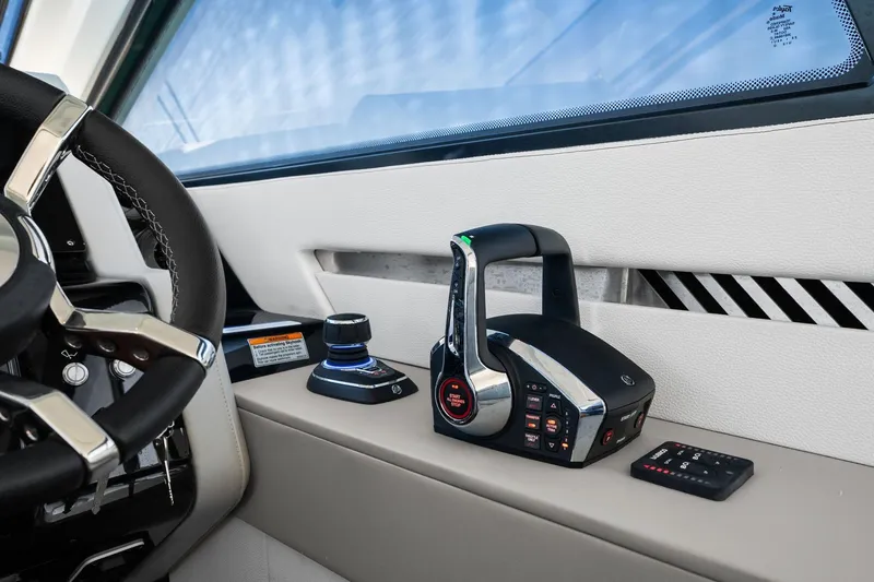 Slide: The Image of 2026 Cruisers Yachts 42 GLS OB helm with modern controls and steering wheel. - 21