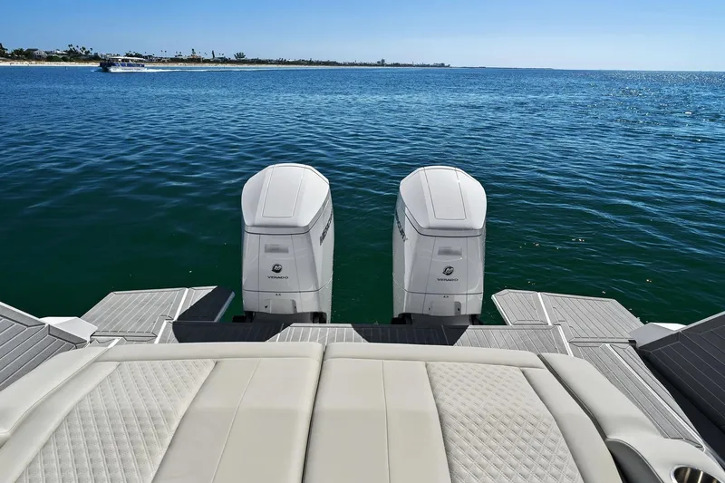 Slide: The Image of Cruisers Yachts 42 GLS OB 2026 on open sea with twin outboard engines. - 10