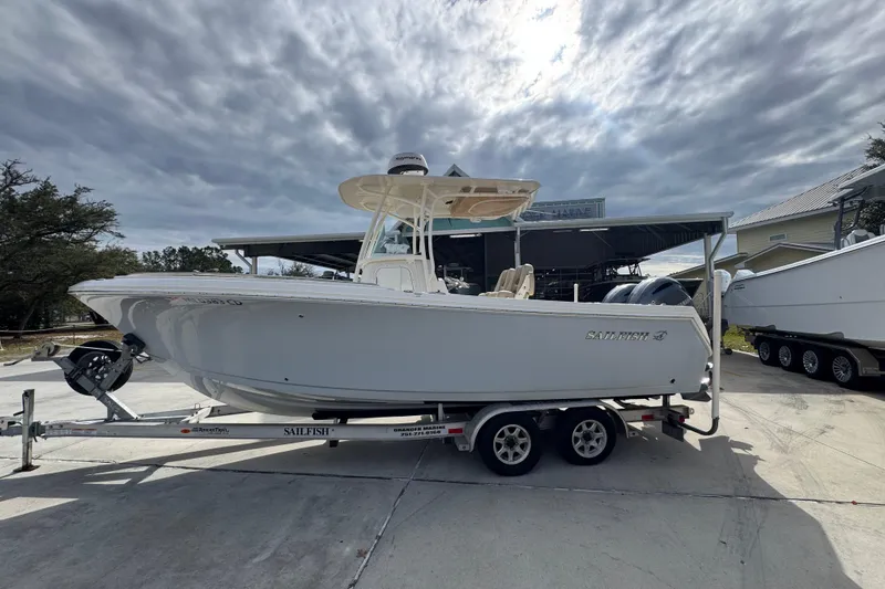 The Image of 2020 Sailfish 242 CC boat on trailer under cloudy sky. - 1