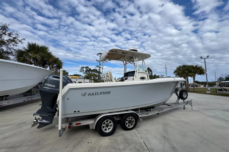 Slide: The Image of 2020 Sailfish 242 CC boat on trailer under cloudy sky. - 11