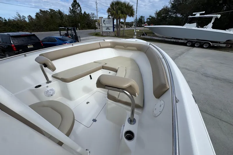 Slide: The Image of 2020 Sailfish 242 CC boat interior with beige seating and stainless steel fixtures. - 18