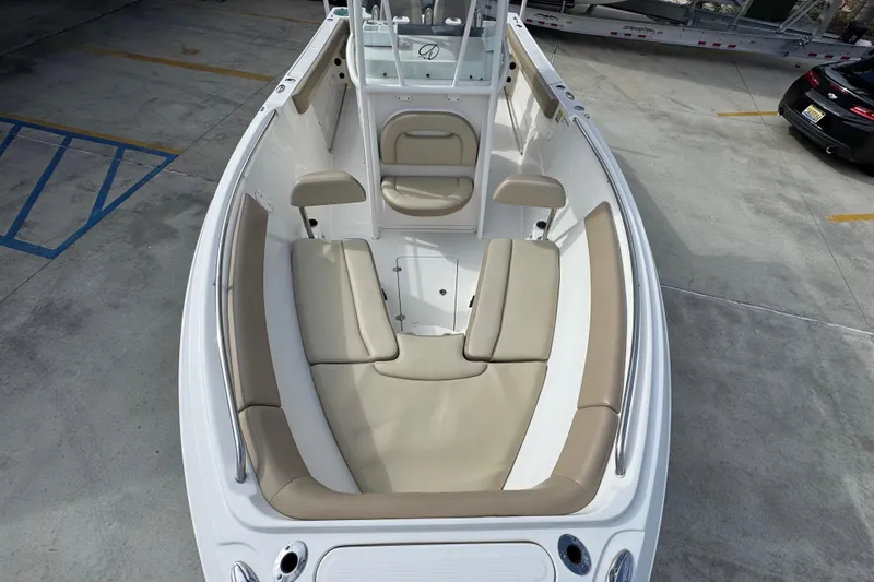 Slide: The Image of 2020 Sailfish 242 CC boat interior with beige seating and white deck. - 21