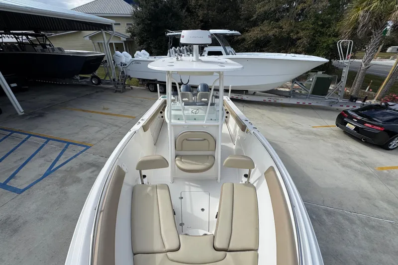 Slide: The Image of 2020 Sailfish 242 CC boat with beige seating, parked in a marina. - 22