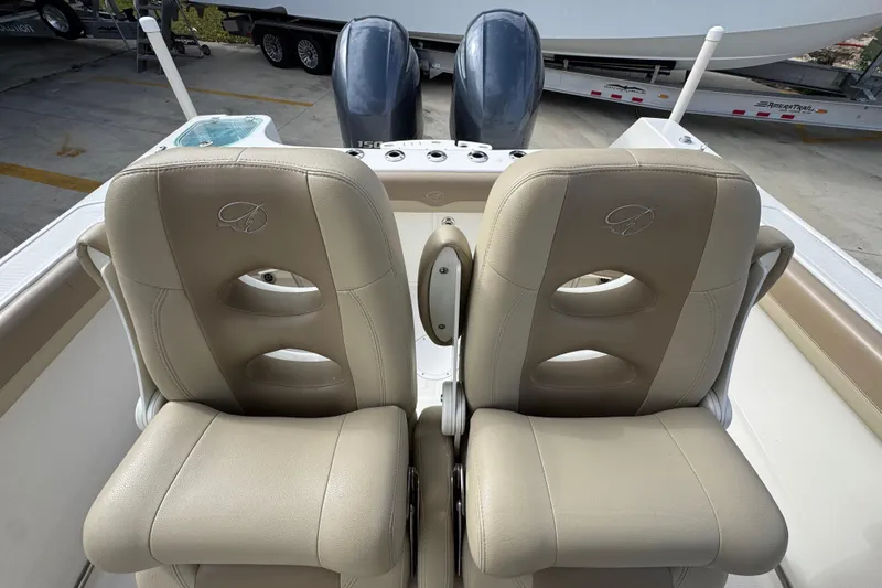 Slide: The Image of 2020 Sailfish 242 CC boat with dual beige captain seats and twin engines. - 29