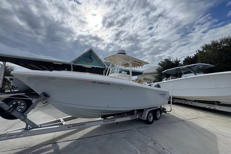 Slide: The Image of 2020 Sailfish 242 CC boat on trailer under cloudy sky. - 3