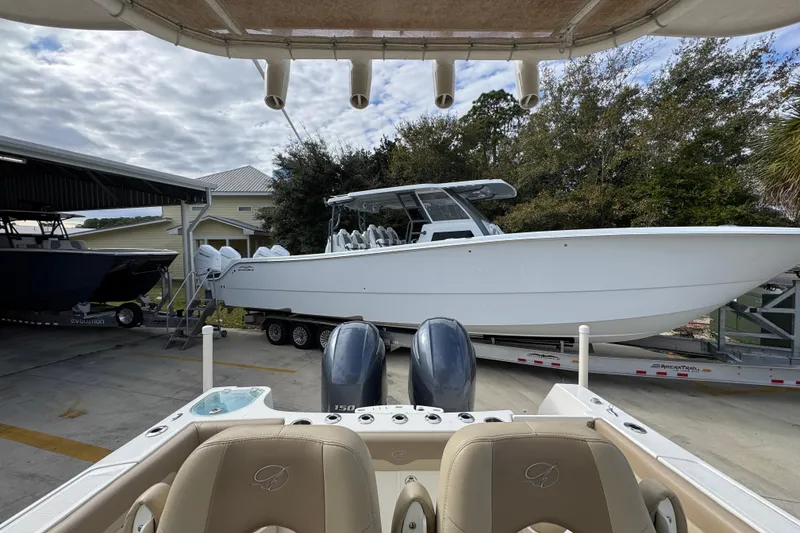 Slide: The Image of 2020 Sailfish 242 CC boat on trailer, viewed from another boat's cockpit. - 30