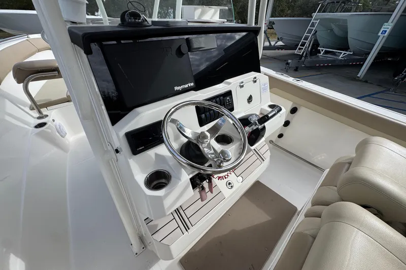 Slide: The Image of 2020 Sailfish 242 CC boat helm with Raymarine electronics and dual seating. - 31