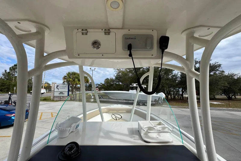 Slide: The Image of 2020 Sailfish 242 CC boat interior with Garmin equipment and cup holders. - 34