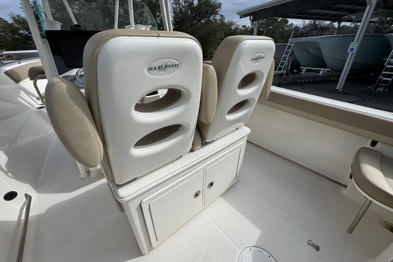 Slide: The Image of 2020 Sailfish 242 CC boat interior with cushioned seats and storage compartments. - 36