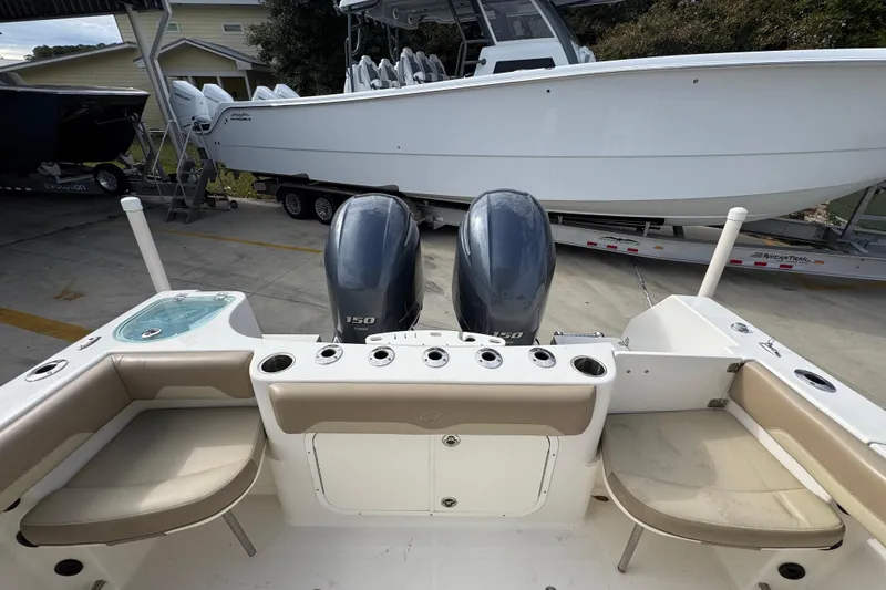 Slide: The Image of 2020 Sailfish 242 CC boat with dual engines and seating, parked on a trailer. - 39