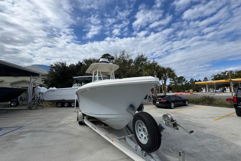 Slide: The Image of 2020 Sailfish 242 CC boat on trailer under cloudy sky in parking lot. - 7