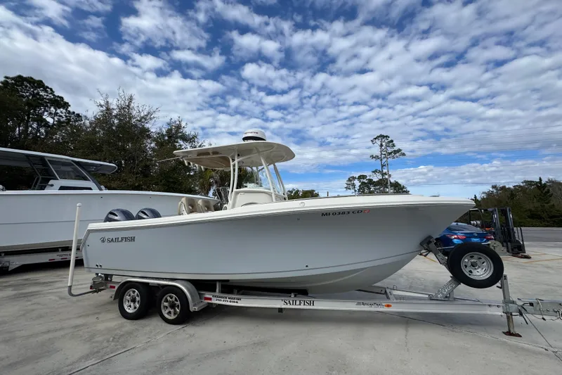 Slide: The Image of 2020 Sailfish 242 CC boat on trailer under cloudy sky. - 9