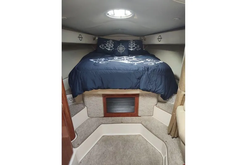 Slide: The Image of 2009 Fountain 38 Express Cruiser cabin with nautical-themed bedding. - 11