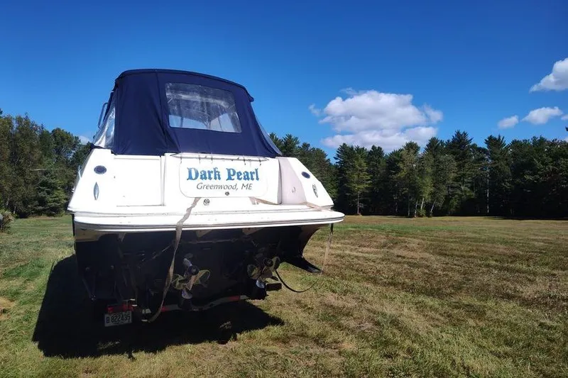 Slide: The Image of 2009 Fountain 38 Express Cruiser "Dark Pearl" on grassy field, clear sky background. - 2