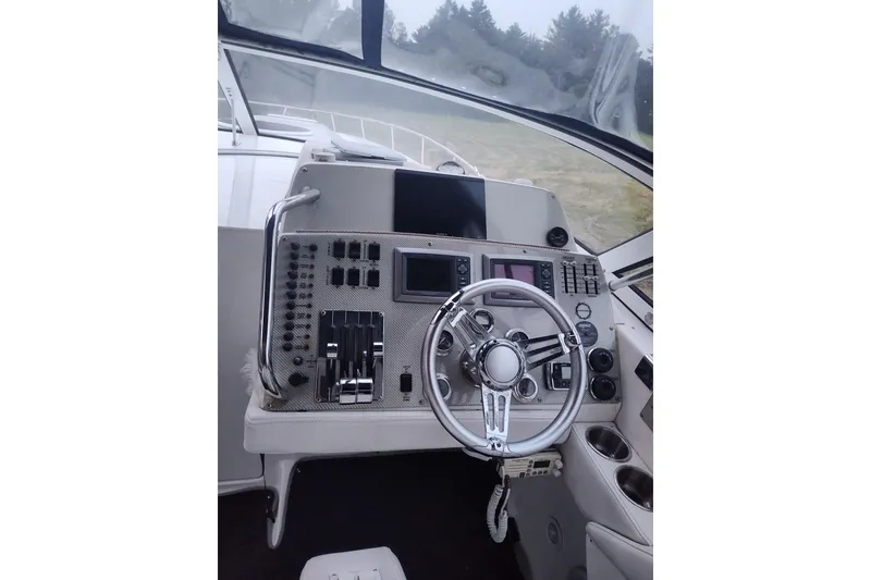 Slide: The Image of 2009 Fountain 38 Express Cruiser helm with advanced navigation controls and steering wheel. - 6