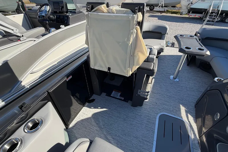 Slide: The Image of 2026 Bennington 22 MFB boat interior with seating, table, and steering console. - 10