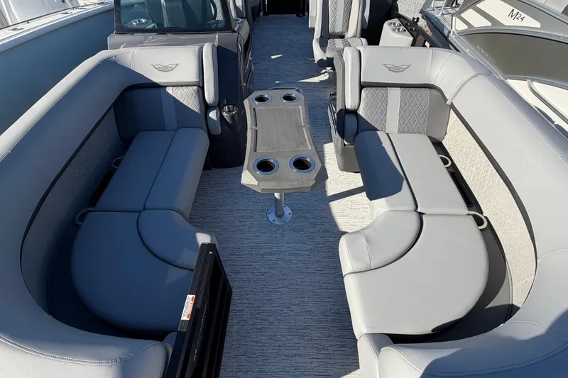 Slide: The Image of 2026 Bennington 22 MFB boat interior with gray seating and central table. - 3
