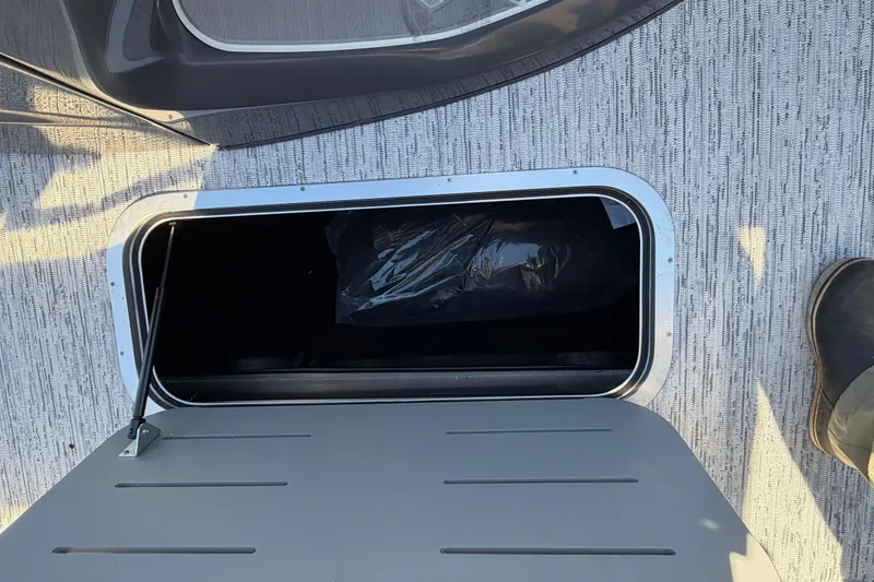 Slide: The Image of Open storage compartment on 2026 Bennington 22 MFB boat, featuring a sleek design. - 9