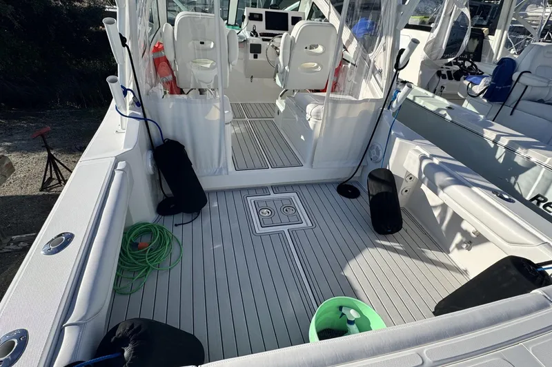 Slide: The Image of 2022 Albemarle 25 Express boat cruising on open water, creating a wake. - 12