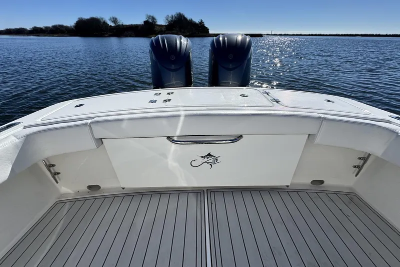 Slide: The Image of 2022 Albemarle 25 Express boat deck with twin engines on a sunny day. - 16