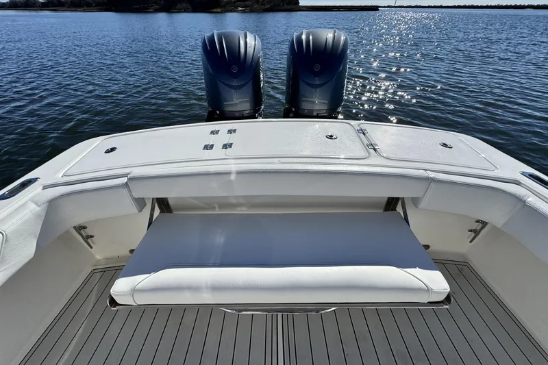 Slide: The Image of 2022 Albemarle 25 Express boat with dual engines and spacious seating on calm water. - 17