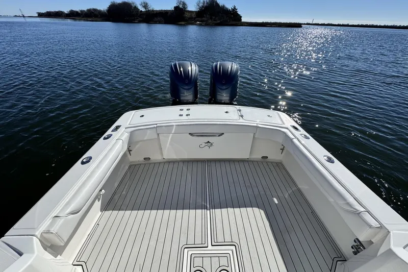 Slide: The Image of 2022 Albemarle 25 Express boat with twin engines on a sunny lake. - 18