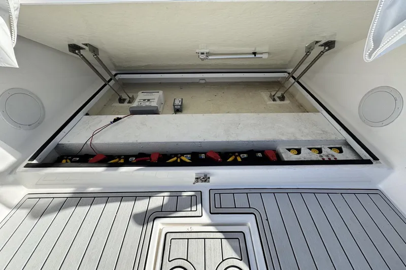 Slide: The Image of 2022 Albemarle 25 Express boat storage compartment with battery setup and wiring. - 20