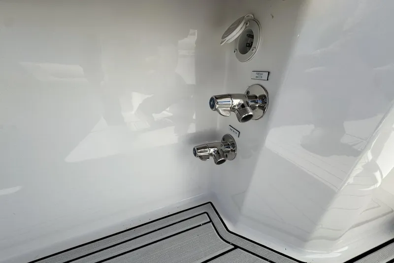 Slide: The Image of 2022 Albemarle 25 Express boat fittings with fresh water and raw water outlets. - 21