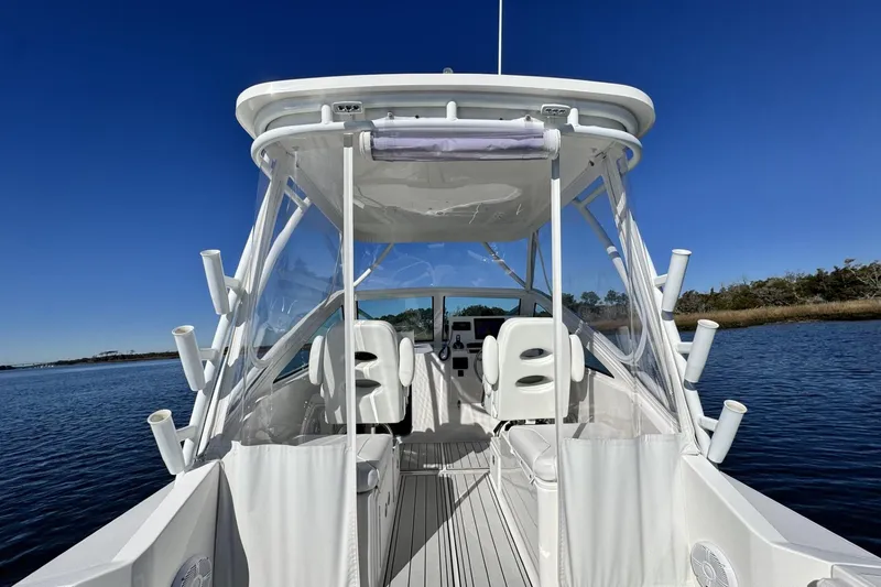 Slide: The Image of 2022 Albemarle 25 Express boat on calm water under clear blue sky. - 22