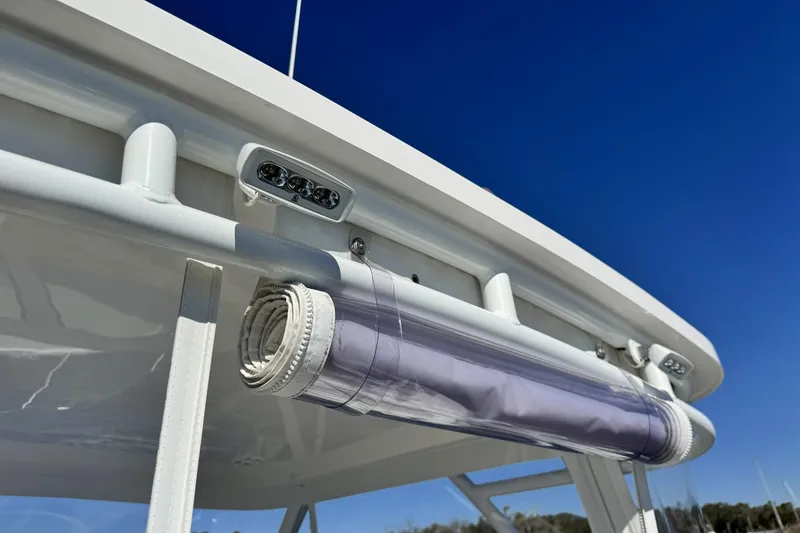 Slide: The Image of 2022 Albemarle 25 Express boat detail with rolled canvas and blue sky background. - 23