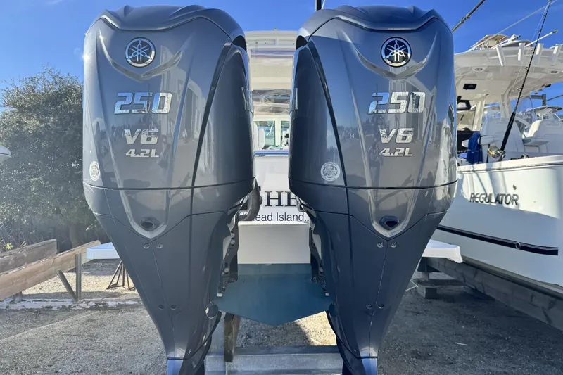 Slide: The Image of 2022 Albemarle 25 Express boat on calm water under clear blue sky. - 3