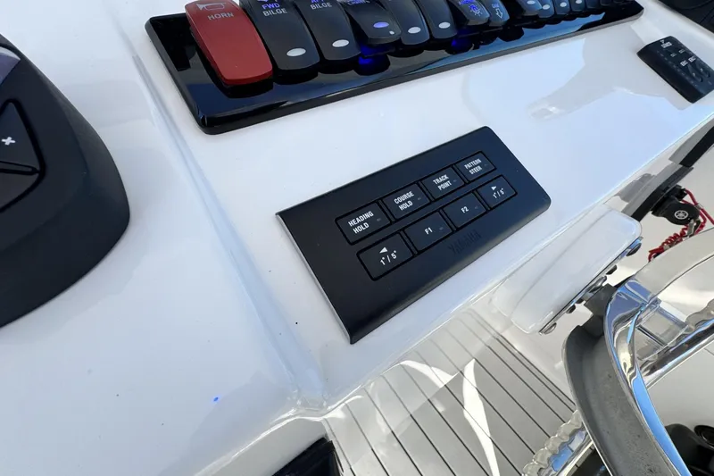 Slide: The Image of Control panel of 2022 Albemarle 25 Express boat with various switches and buttons. - 32
