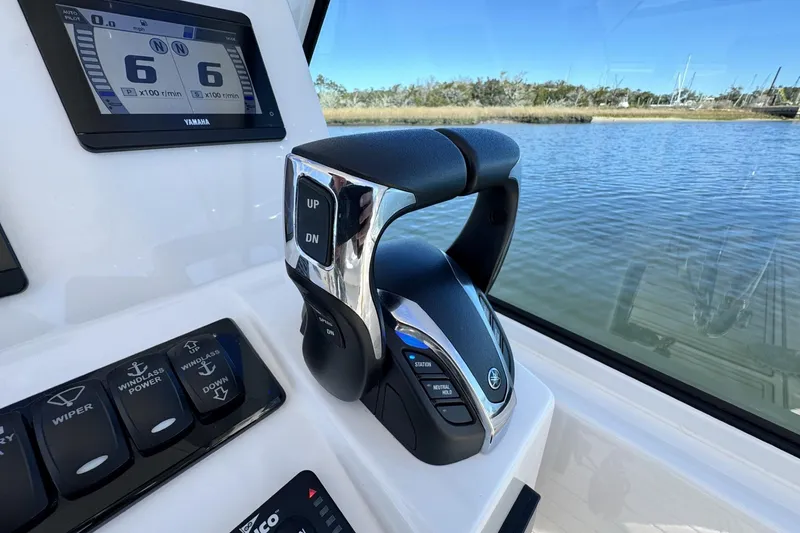 Slide: The Image of 2022 Albemarle 25 Express boat controls with Yamaha display, near water. - 34