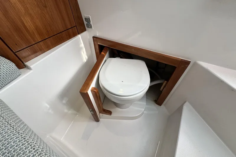 Slide: The Image of 2022 Albemarle 25 Express boat interior with compact marine toilet. - 37