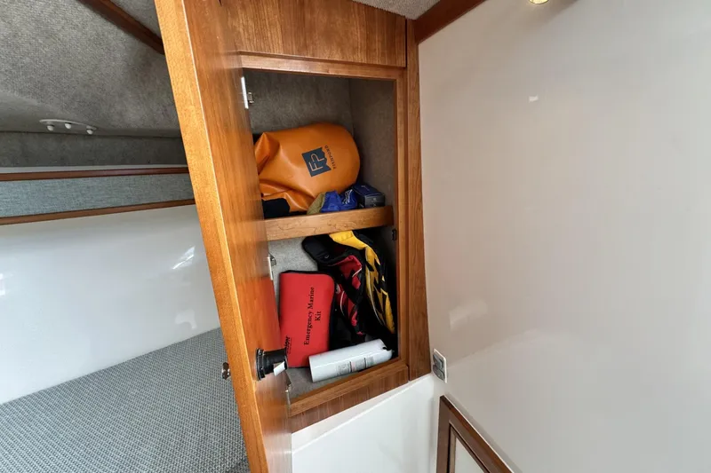Slide: The Image of 2022 Albemarle 25 Express cabin storage with emergency marine kit and gear. - 38