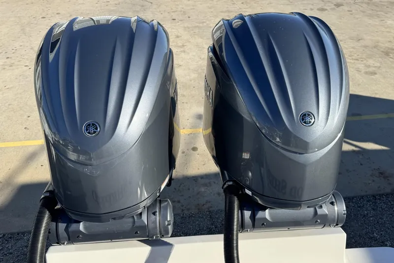 Slide: The Image of 2022 Albemarle 25 Express boat cruising near a scenic shoreline with a lighthouse. - 4