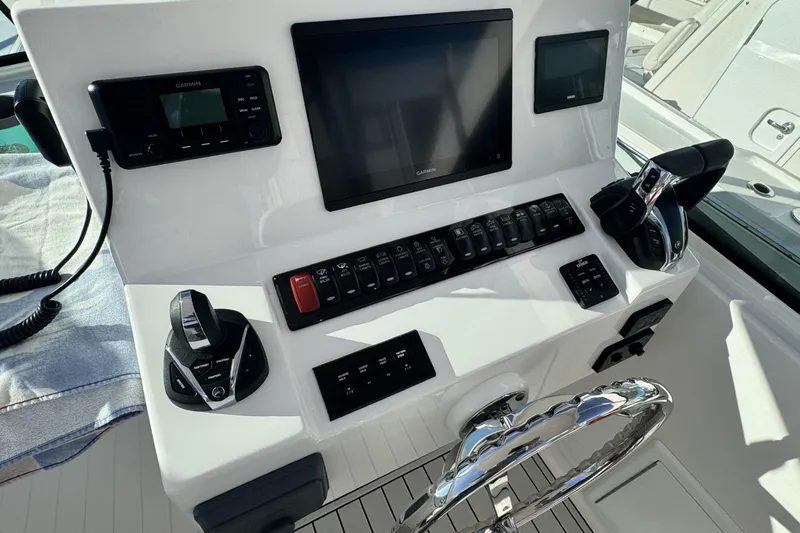 Slide: The Image of 2022 Albemarle 25 Express boat on water, featuring spacious deck and seating area. - 7