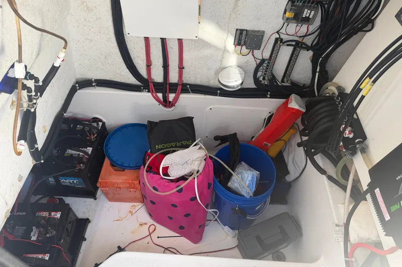 Slide: The Image of 2024 Clearwater 2800 boat storage compartment with batteries and equipment. - 25