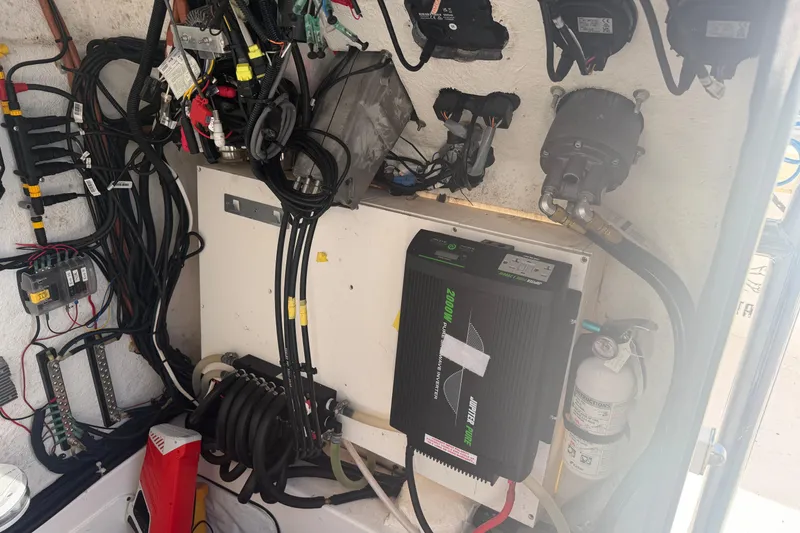 Slide: The Image of Electrical system inside a 2024 Clearwater 2800 boat, featuring wiring and components. - 27