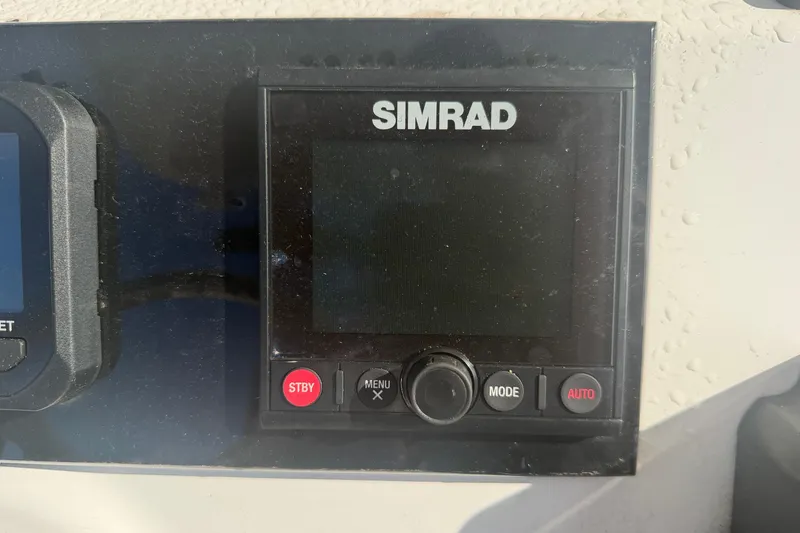 Slide: The Image of Simrad display on 2024 Clearwater 2800 boat dashboard, featuring control buttons. - 36