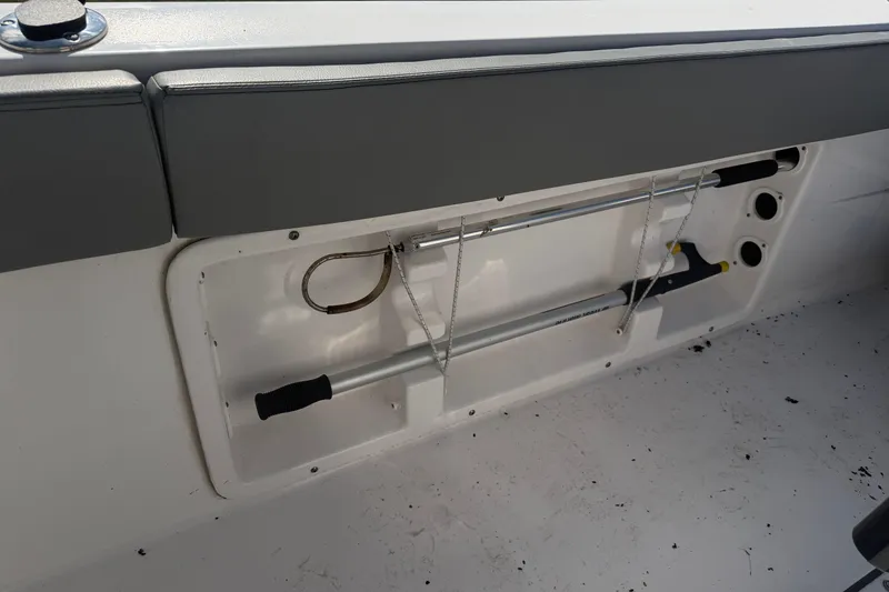 Slide: The Image of 2024 Clearwater 2800 boat interior storage compartment with tools and accessories. - 40