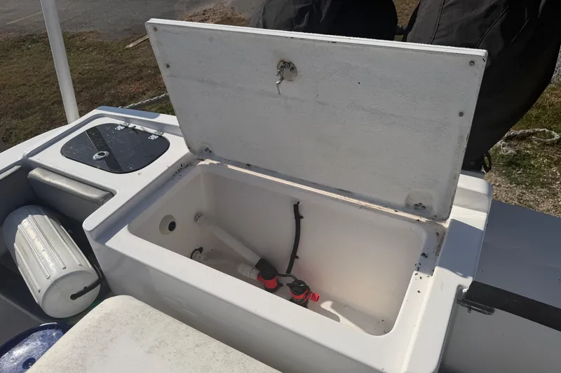 Slide: The Image of Open storage compartment on 2024 Clearwater 2800 boat, showing interior details. - 50