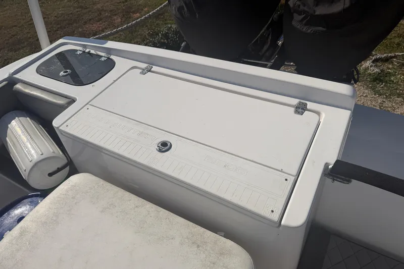 Slide: The Image of 2024 Clearwater 2800 boat deck with storage compartment and fender. - 51