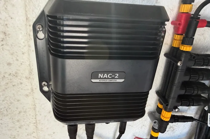 Slide: The Image of 2024 Clearwater 2800 NAC-2 autopilot computer mounted on wall with connected cables. - 53