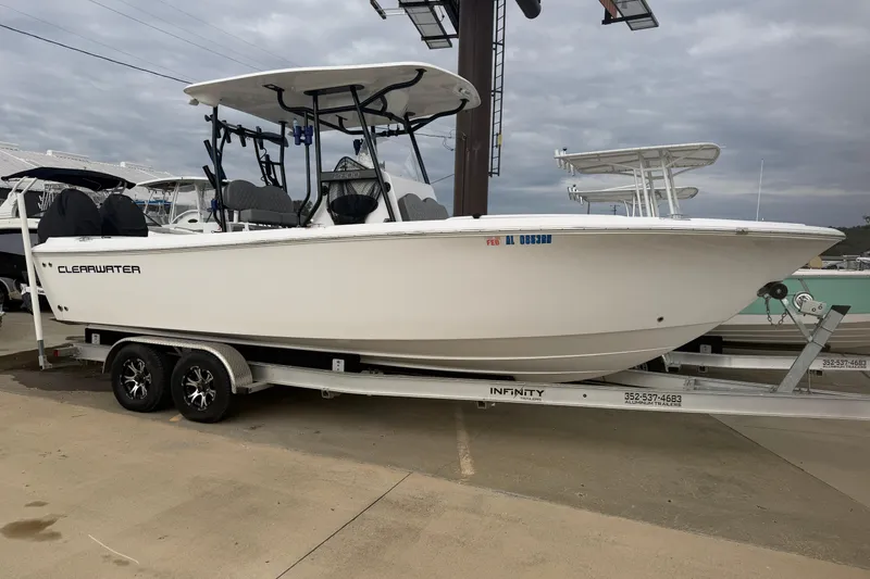 The Image of 2024 Clearwater 2800 boat on trailer, displayed outdoors under cloudy sky. - 1